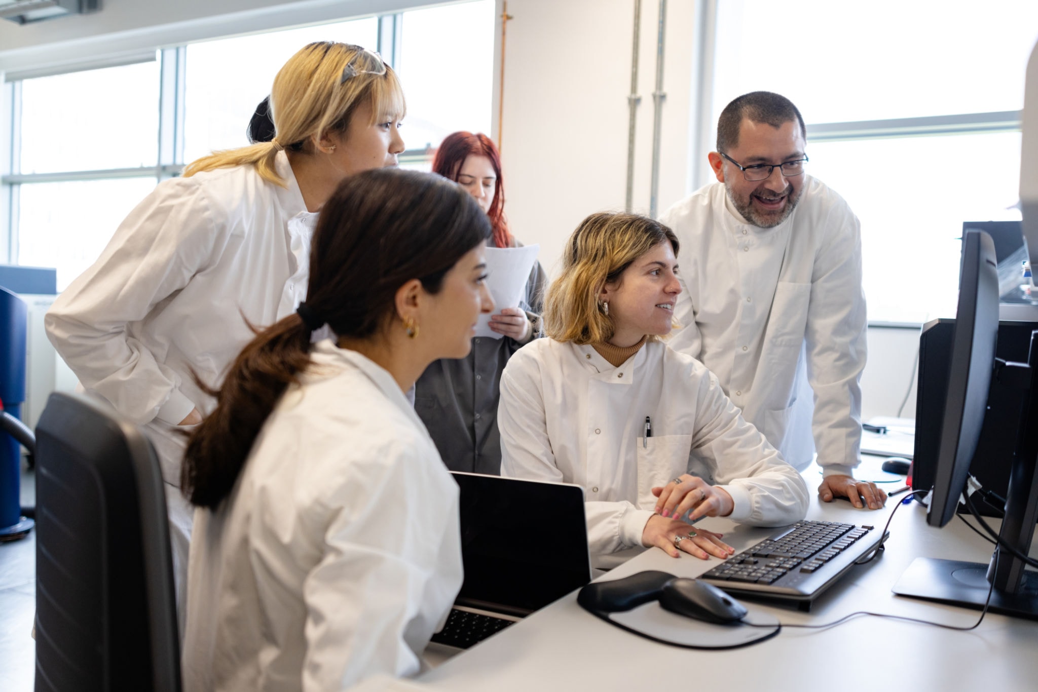 Life sciences team collaborating at workstation